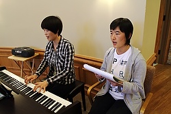 Chinese Sisters Jean Qi Zhi Zhen, left, a member of the Sisters of St. Theresa of the Child Jesus, and Paulina Feng Shuang, a member of the Fushun Sisters of the Sacred Heart of Jesus, lead the music during an Aug. 20 Mass affiliated with Maryknoll's Chinese Seminary Teachers and Formators Project. (CNS photo/Gregory A. Shemitz)