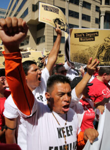 Protesters shout during an immigration rally and march outside the U.S. Immigration and Customs Enforcement headquarters in Washington Aug. 28. (CNS photo/Bob Roller)