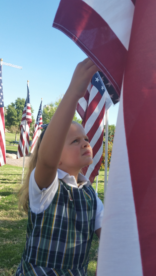 Taylor's mom wrote the following about her photo: This moment brought it home for me. How discipline, self control, and love for others serves our country throughout a lifetime. Without these things freedom is not possible. Seeing Taylor in her SJB uniform amongst the flags was a stark reminder of the presence of the Church in our culture today. (courtesy photo)