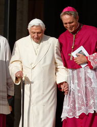 Retired Pope Benedict XVI is assisted by Archbishop Georg Ganswein, prefect of the papal household, as he arrives for Pope Francis' encounter with the elderly in St. Peter's Square at the Vatican Sept. 28. (CNS photo/Paul Haring)