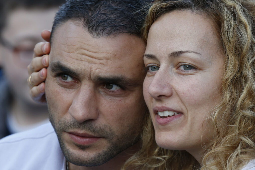A couple wait for the start of an Oct. 4 prayer vigil led by Pope Francis for the extraordinary Synod of Bishops on the family in St. Peter's Square at the Vatican. The pope called for "sincere, open and fraternal" debate during the two-week long synod, which opened Oct. 5. (CNS photo/Paul Haring)