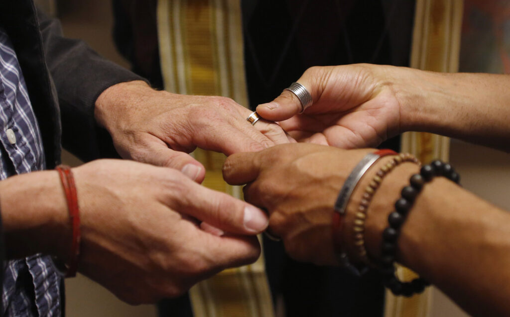 Jim Derrick and Alfie Travassos exchange rings as they get married at the Salt Lake County Government Complex in Salt Lake City Oct. 6. In reaction to the U.S. Supreme Court declining to review rulings overturning state bans on same-sex marriage, U.S. Catholic bishops reiterated church teaching on traditional marriage, that it is a union between one man and one woman. (CNS photo/Jim Urquhar, Reuters)