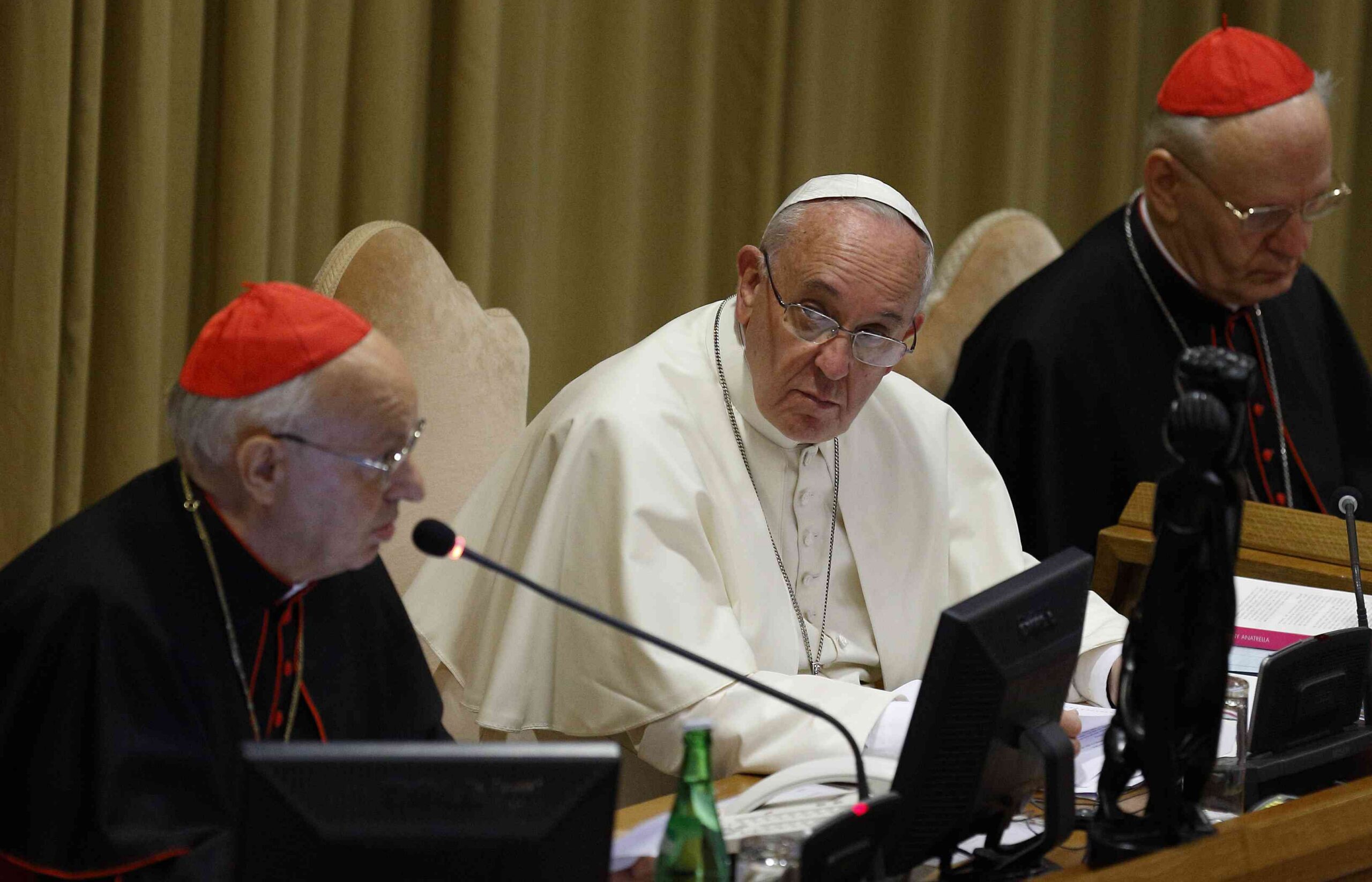 Pope Francis listens as Italian Cardinal Lorenzo Baldisseri, general secretary of the Synod of Bishops, left, speaks during the morning session of the extraordinary Synod of Bishops on the family at the Vatican Oct. 13. At right is Cardinal Peter Erdo of Esztergom-Budapest, Hungary, relator for the synod. (CNS photo/Paul Haring)
