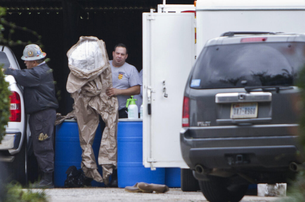 Members of a hazardous material team prepare to enter the apartment Oct. 13 of the health worker who was infected with the Ebola virus at Texas Health Presbyterian Hospital in Dallas. Nina Pham, a Vietnamese Catholic nurse, contracted the deadly virus while treating a patient at the hospital. A prayer service was held Oct. 12 for Pham at Our Lady of Fatima Church in Fort Worth, where she and her family are active members. (CNS photo/Jaime R. Carrero, Reuters)