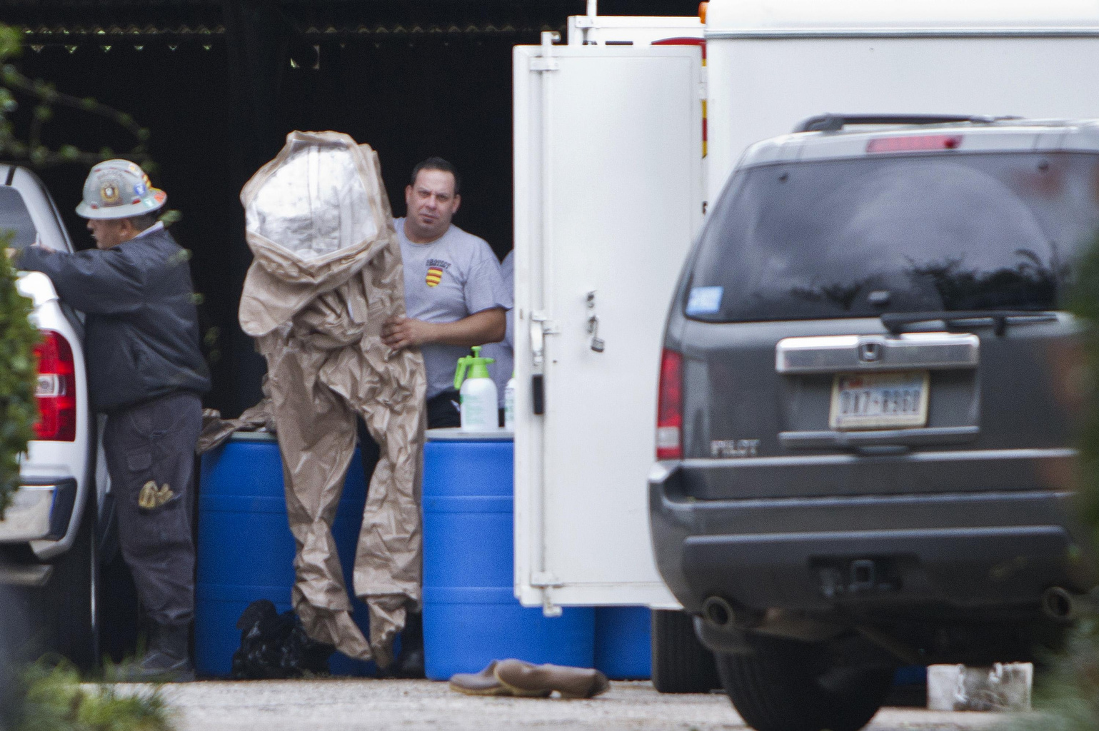 Members of a hazardous material team prepare to enter the apartment Oct. 13 of the health worker who was infected with the Ebola virus at Texas Health Presbyterian Hospital in Dallas. Nina Pham, a Vietnamese Catholic nurse, contracted the deadly virus while treating a patient at the hospital. A prayer service was held Oct. 12 for Pham at Our Lady of Fatima Church in Fort Worth, where she and her family are active members. (CNS photo/Jaime R. Carrero, Reuters)