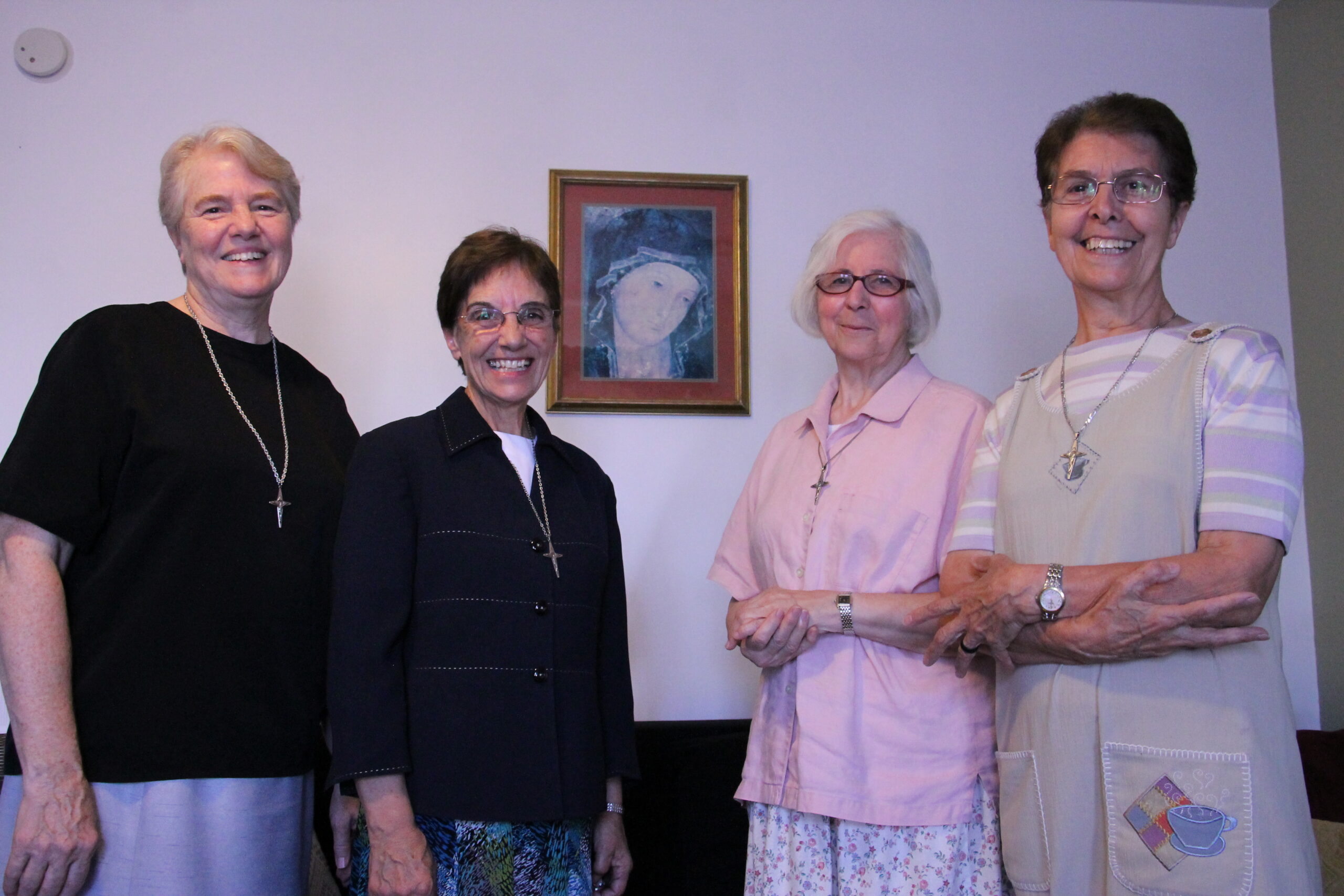 Consolata Missionary Sisters Jo Marie Williams, Maria Dina Puddu, Adelangela Paita and Riccardina Silvestri briefly unite around the image of Our Lady of Consolata Oct. 19 before heading into the community to pray with local Catholics. (Ambria Hammel/CATHOLIC SUN)