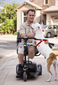 Veteran David Campbell spends time with his dog, Sugar, outside his home in Chandler, Ariz., Oct. 19. Campbell served in operations Desert Storm and Desert Shield in the early 1990s and was severely injured in a grenade explosion that nearly took his life. His message to others who have been through traumatic events is: "Help is out there and healing is possible." (CNS photo/Nancy Wiechec)