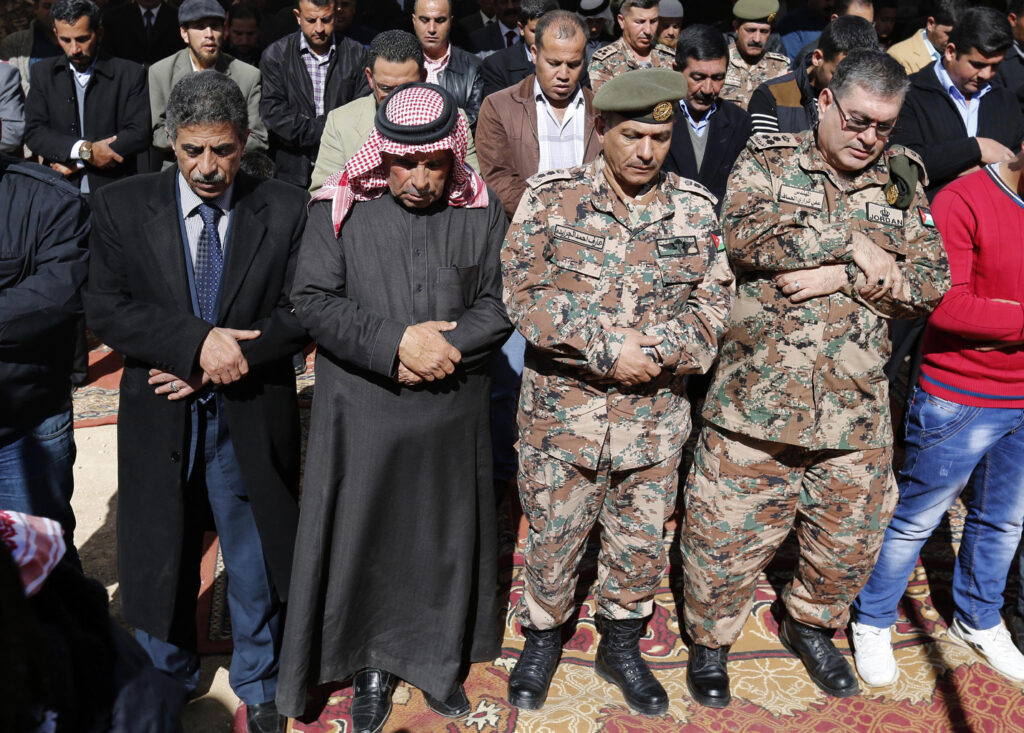 Saif al-Kasasbeh, second from left, father of First Lt. Muath al-Kasasbeh, Jordanian pilot, prays in Jordan Feb. 4 with other mourners during an event commemorating the Islamic State murder of the pilot. (CNS photo/Jasmal Nasrallah, EPA)