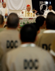 Cardinal Francis E. George of Chicago celebrates Mass with detainees at a Cook County medium-security facility in Chicago Dec. 25. The cardinal also made a stop at Children's Memorial Hospital to visit with children who are hospitalized and could not be home for Christmas and their families. (CNS photo/Karen Callaway, Catholic New World)