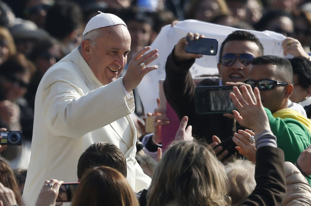 Pope Francis greets the crowd as he arrives to lead his general audience in St. Peter's Square at the Vatican March 11. (CNS photo/Paul Haring)