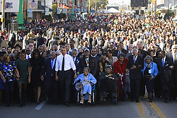 U.S. President Barack Obama and his family participate in a march across the Edmund Pettus Bridge in Selma, Ala., March 7. Demonstrators from across the country sang while retracing the steps of those who marched 50 years ago for civil rights with the Rev. Martin Luther King Jr. over the bridge from Selma to Montgomery, Ala. (CNS photo/Jonathan Ernst, Reuters)