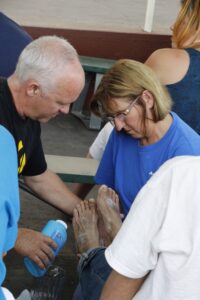 Volunteers wash the feet of an André House guest on Holy Thursday April 2 in remembrance of the humble act of Jesus and His call to humble servitude. (Ambria Hammel/CATHOLIC SUN)