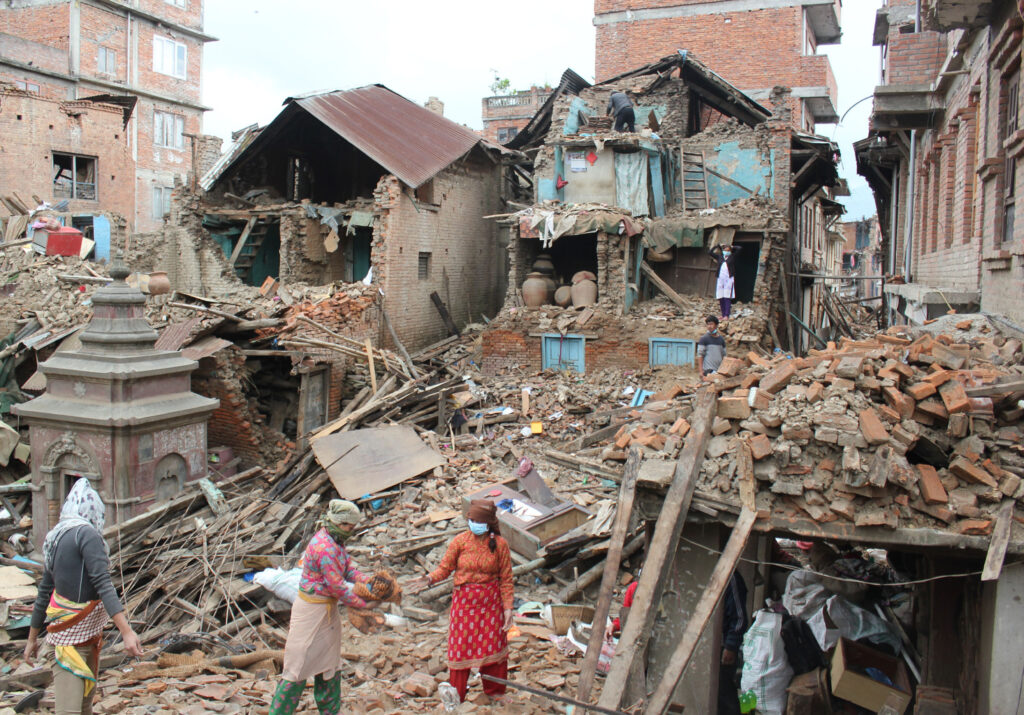 Earthquake survivors of Harsiddhi village on the outskirts of Kathmandu, Nepal, retrieve belongings from their destroyed homes April 29, five days after a major earthquake struck the region. (CNS photo/Anto Akkara) April 29, 2015.