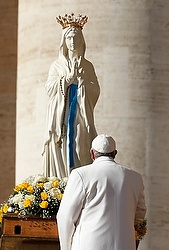 Pope Francis prays in front of a statue of Mary as he begins his general audience in St. Peter's Square at the Vatican Feb. 11. (CNS photo/Paul Haring)