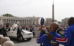 Members of the Harlem Globetrotters watch as Pope Francis arrives to lead his general audience in St. Peter's Square at the Vatican May 6. (CNS photo/Paul Haring)