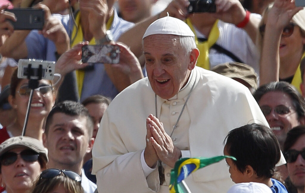 Pope Francis gestures as he greets the crowd during his general audience in St. Peter's Square at the Vatican May 20. (CNS photo/Paul Haring)