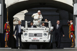 Pope Francis passes Swiss Guards as he arrives to lead his general audience in St. Peter's Square at the Vatican May 27. (CNS photo/Paul Haring)
