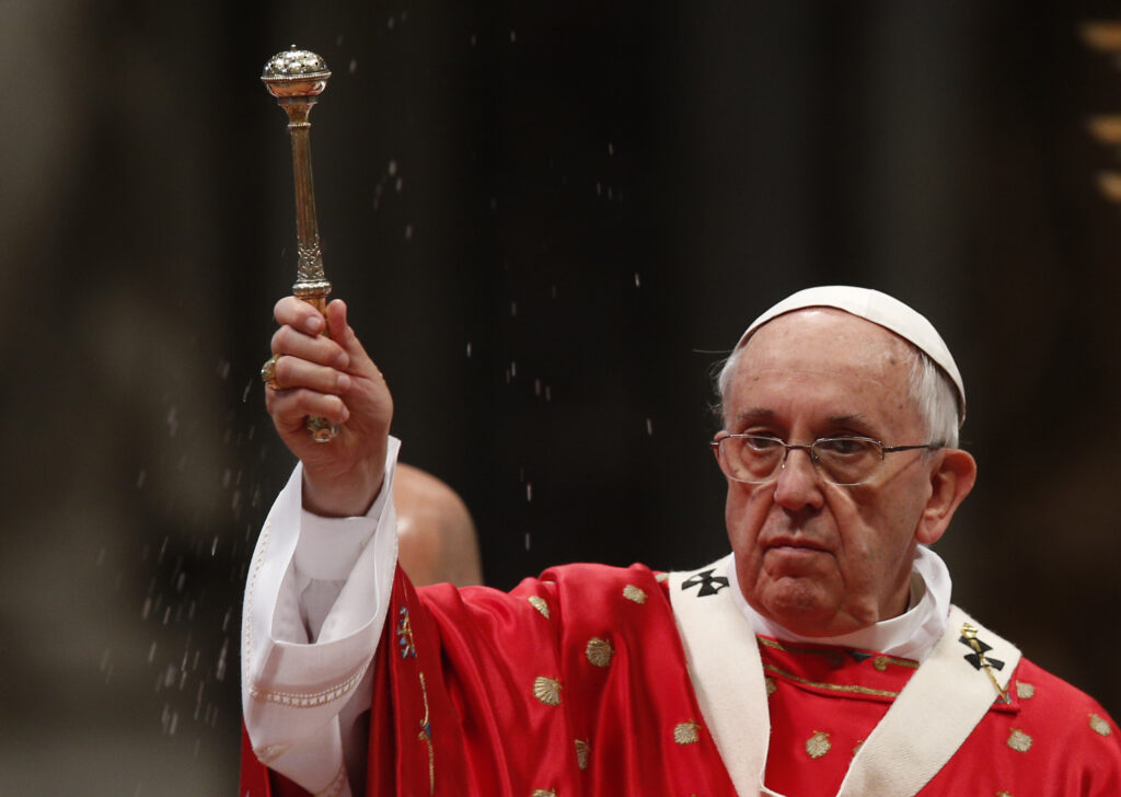 Pope Francis blesses the faithful with holy water as he celebrates Pentecost Mass in St. Peter's Basilica at the Vatican May 24. (CNS photo/Paul Haring)