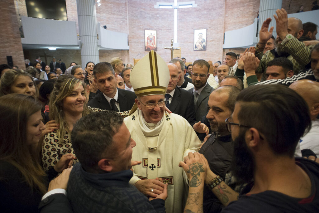Pope Francis greets inmates after celebrating Mass on Holy Thursday, April 2, at Rebibbia prison in Rome. The pope regularly visits with prisoners, a practice he began while archbishop of Buenos Aires. (CNS photo/L'Osservatore Romano via Reuters) 