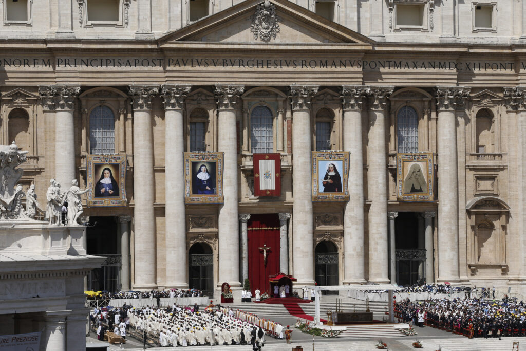 Banners showing new Saints Marie-Alphonsine, Jeanne Emilie De Villeneuve, Maria Cristina Brando and Mary of Jesus Crucified hang from the facade of St. Peter's Basilica during their canonization Mass celebrated by Pope Francis in St. Peter's Square at the Vatican May 17. (CNS photo/Paul Haring)