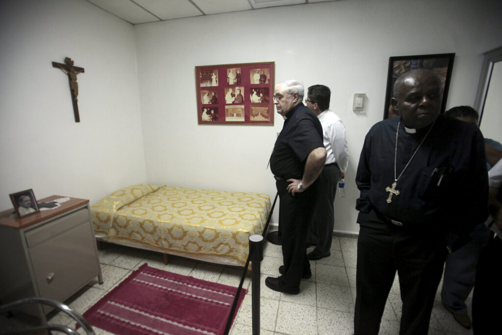 Members of the clergy and other pilgrims visit the bedroom of Archbishop Oscar Romero at Divine Providence Hospital in San Salvador May 21, two days before the beatification of the prelate, who was shot by unidentified gunmen as he celebrated Mass in the hospital chapel March 24, 1980. (CNS photo/Reuters)