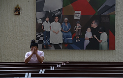 A woman prays in the chapel of Divine Providence Hospital in San Salvador May 21, two days before the beatification of Archbishop Oscar Romero, who was shot by unidentified gunmen as he celebrated Mass in the hospital chapel March 24, 1980. (CNS photo/Lissette Lemus)