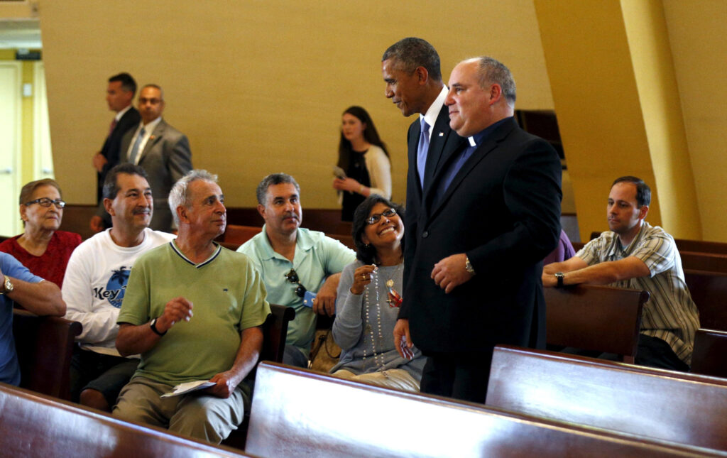 U.S. President Barack Obama makes an unannounced stop to the Shrine of Our Lady of Charity in Miami, Florida May 28. Walking with the president is Father Juan Rumin Dominguez. The shrine is named for the patroness of Cuba and the Cuban people. (CNS photo/Kevin Lamarque, Reuters) 