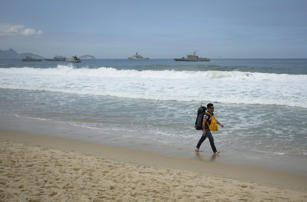 A pilgrim walks Copacabana beach following the World Youth Day closing Mass in Rio de Janeiro in this 2013 file photo (CNS photo/Tyler Orsburn)