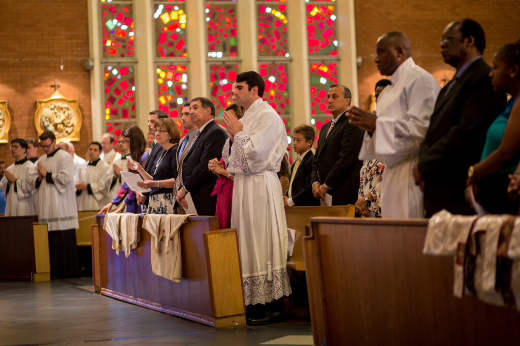 Ryan Lee stands with his family moments before being ordained a deacon on his path to the priesthood during the diaconate ordination Mass at Ss. Simon and Jude Cathedral on May 31. (Billy Hardiman/CATHOLIC SUN)