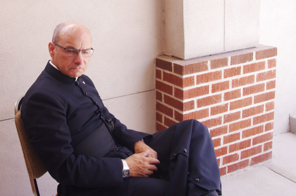 Fr. Joseph Terra, FSSP sits outside Mater Misericordiae Mission, the site of a deadly attack that took place June 11, 2014. (Joyce Coronel/CATHOLIC SUN)