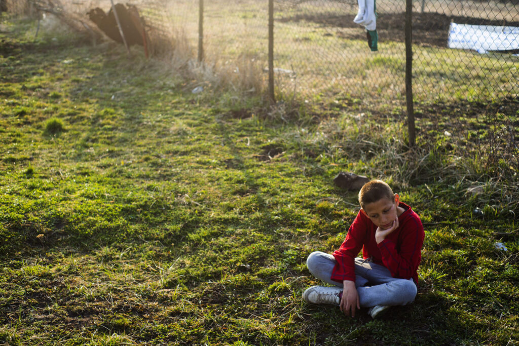 A Roma boy sits in the backyard of a house in Gyongyospata, Hungary, March 24. Pope Francis said focusing on poverty and sacrificing for the poor are the heart of the Gospel, not signs of communism. (CNS photo/Zoltan Balogh, EPA)