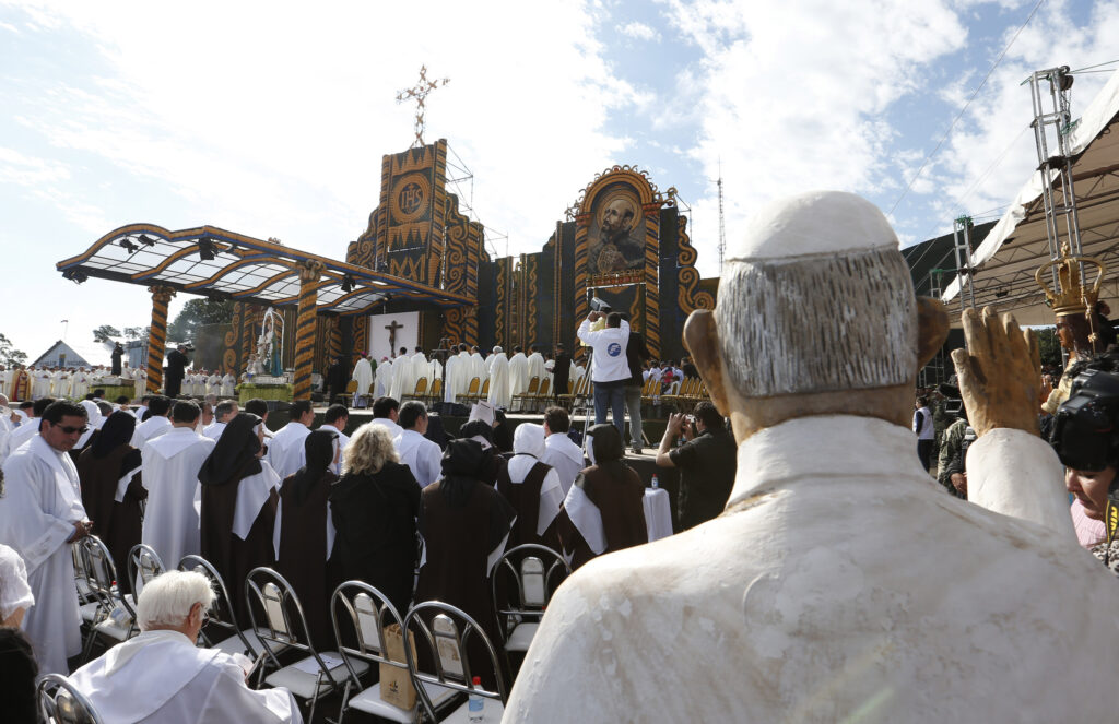 A statue of Pope Francis is seen as the pope celebrates Mass in Nu Guazu Park in Asuncion, Paraguay, July 12. (CNS photo/Paul Haring)