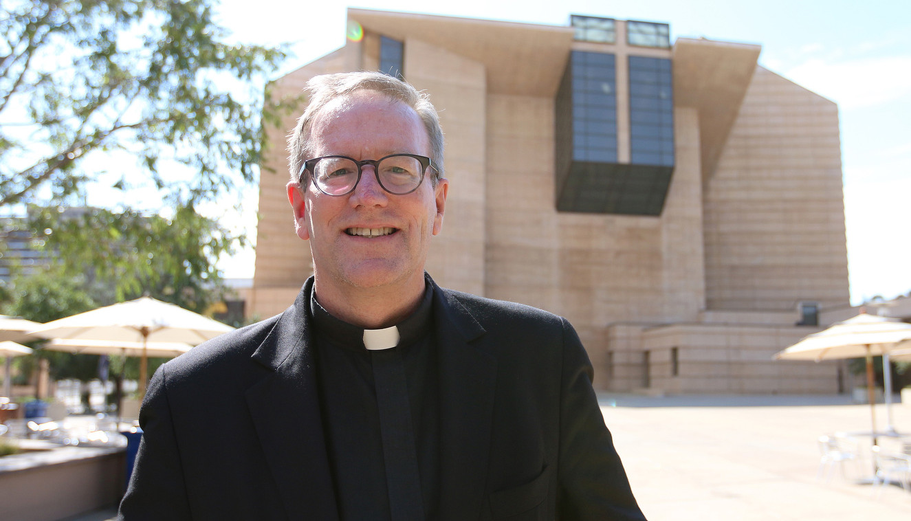 Father Robert Barron is pictured in front of the Cathedral of Our Lady of the Angels in Los Angeles July 20. Pope Francis has named Father Barron an auxiliary bishop for the Archdiocese of Los Angeles. Father Barron, 55, is a native of Chicago who has served as rector of Mundelein Seminary and president of the University of St. Mary of the Lake, also in Mundelein, Ill., since 2012. (CNS photo/J.D. Long-Garcia, The Tidings)