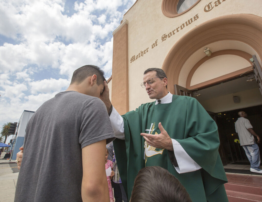 Msgr. Joseph V. Brennan, pictured giving a blessing outside Mother of Sorrows Church in Los Angeles July 19, has been named by Pope Francis as an auxiliary bishop for the Archdiocese of Los Angeles. Msgr. Brennan, 61, vicar general and moderator of the curia in Los Angeles since 2013, is a native of Van Nuys, Calif., whose studies and assignments have all been in the Southern California archdiocese. (CNS photo/John Rueda, The Tidings)