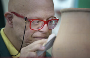 Naji smoothes pottery in late May at Phenix Group Homes, an organization in Beirut that provides residential and day care for people living with intellectual disabilities. (CNS photo/Paul Jeffrey)