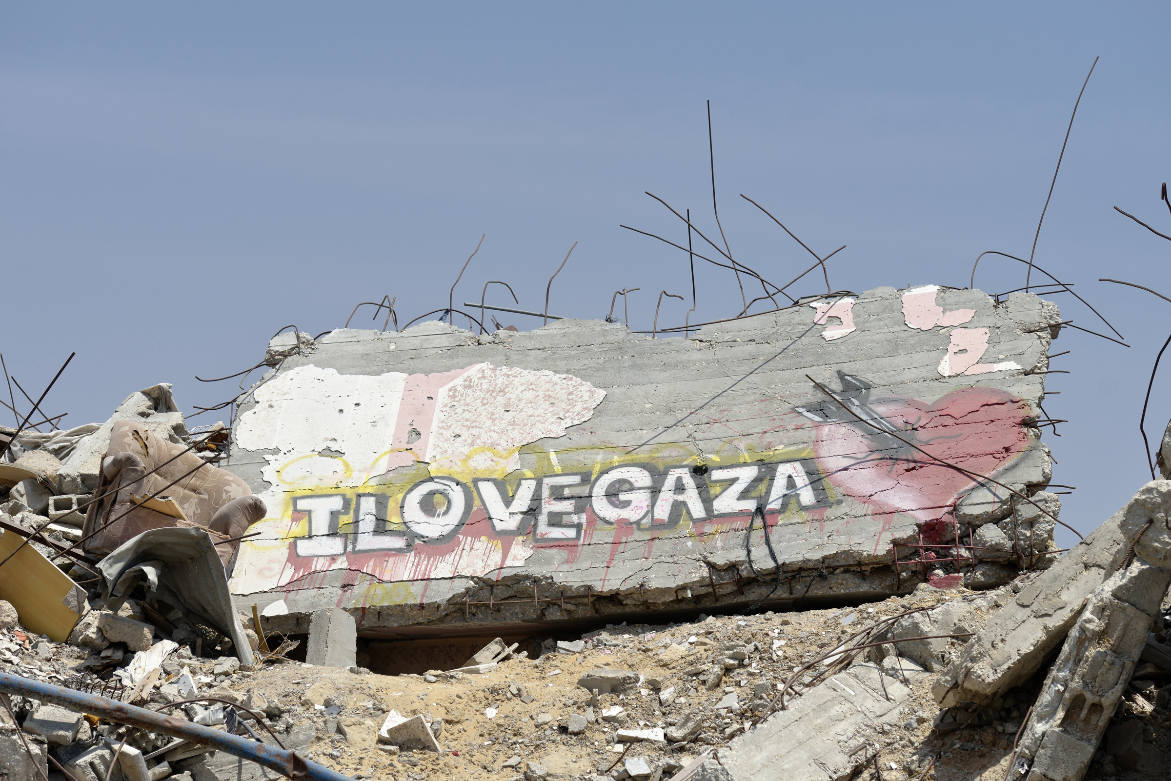 Neighborhood rubble with a message painted on a wall is seen in Gaza City June 6. Houses in the area were destroyed during the 2014 war between Israel and the Hamas government of Gaza. (CNS photo/Paul Jeffrey) See GAZA-HOUSING July 17, 2015.