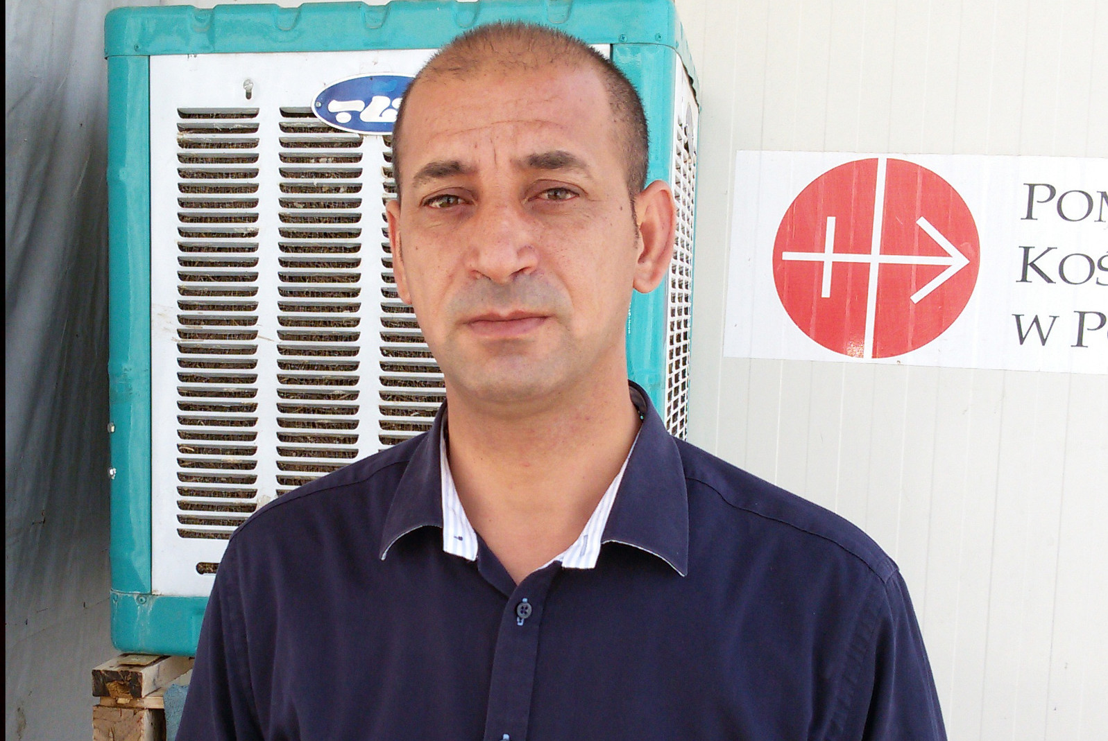 Fr. Bashar Kthea, 39, a Syriac Catholic priest, poses for a photo July 17 in Irbil, Iraq. Initially living in his car after fleeing the town of Qaraqosh, Iraq, last August, when Islamic State forces overran it, he now ministers in a camp for displaced Christians in a Kurdish-controlled part of the country. (CNS photo/Sahar Mansour)