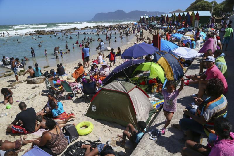 In this 2013 file photo, people spend time on St. James beach in Cape Town, South Africa. (CNS photo/Nic Bothma, EPA)