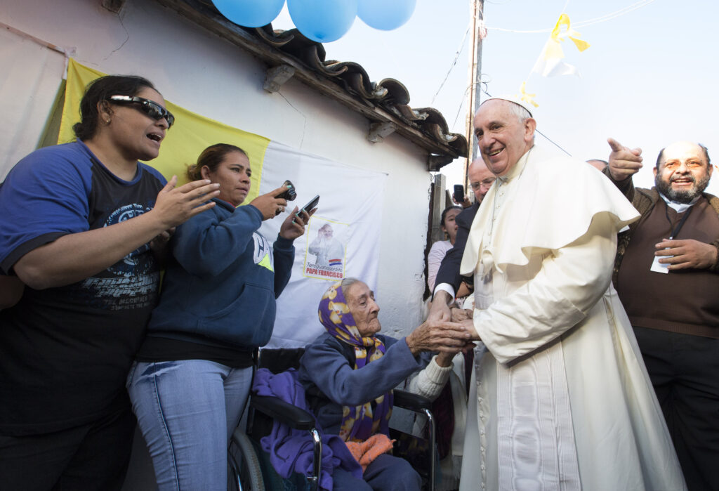 Pope Francis greets an elderly woman as he meets with people of Banado Norte, a poor neighborhood in Asuncion, Paraguay, July 12. (CNS photo/Paul Haring) See POPE-BANADO July 12, 2015.