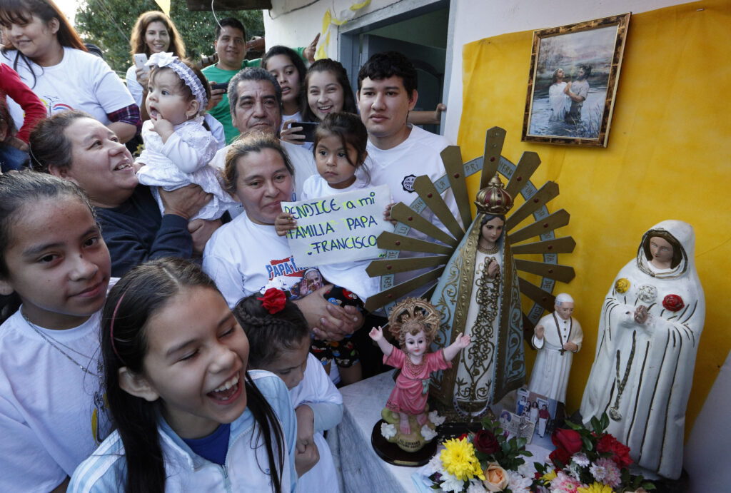 People wait for Pope Francis' arrival to Banado Norte, a poor neighborhood in Asuncion, Paraguay, July 12. (CNS photo/Paul Haring)