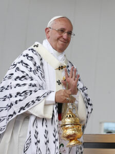 Pope Francis waves as he recognizes someone while using incense during Mass in Bicentennial Park in Quito, Ecuador, July 7. (CNS photo/Paul Haring)