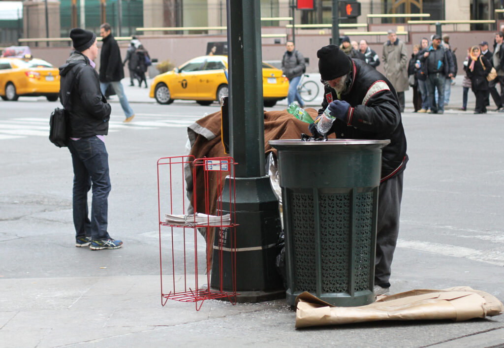A homeless man searches a trash can for bottles and cans to redeem for money in New York City in 2014. Ahead of Pope Francis' apostolic visit to the United States in September, some are bracing themselves for more criticisms from the pope, this time directed specifically at the U.S. culture and economy. (CNS photo/Gregory A. Shemitz)