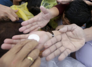 Pilgrims reach to receive Communion as Pope Francis celebrates Mass Jan. 18 in Manila, Philippines. As Catholics prepare for the world Synod of Bishops on the family in October, a number of church leaders and theologians are discussing ways to reach out to divorced and civilly remarried Catholics. (CNS photo/Francis Maalasig, EPA)
