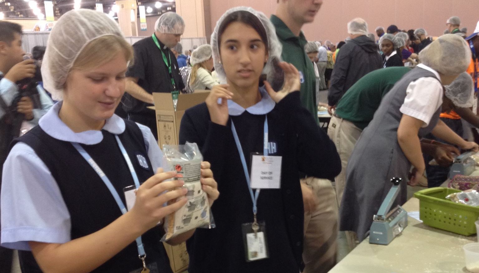 Lacey Powers helps package 200,000 meals to families in West Africa. (Gina Keating/CATHOLIC SUN)