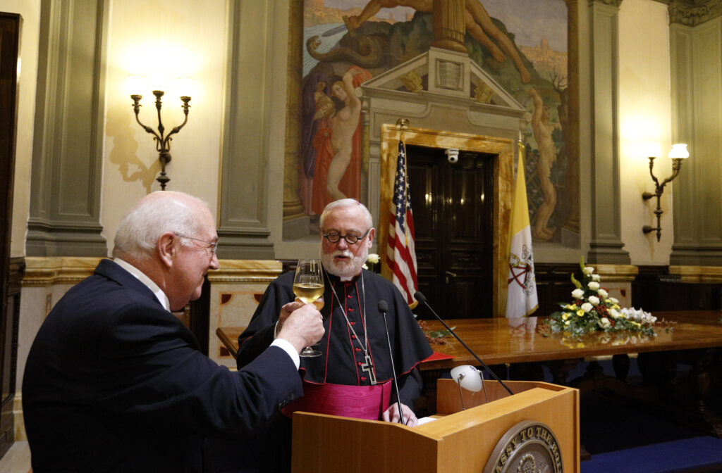 Ken Hackett, U.S. ambassador to the Holy See, raises a glass with Archbishop Paul Gallagher, Vatican foreign minister, during a reception for the inauguration of the new headquarters of the U.S. Embassy to the Holy See in Rome Sept. 9. (CNS photo/Paul Haring)