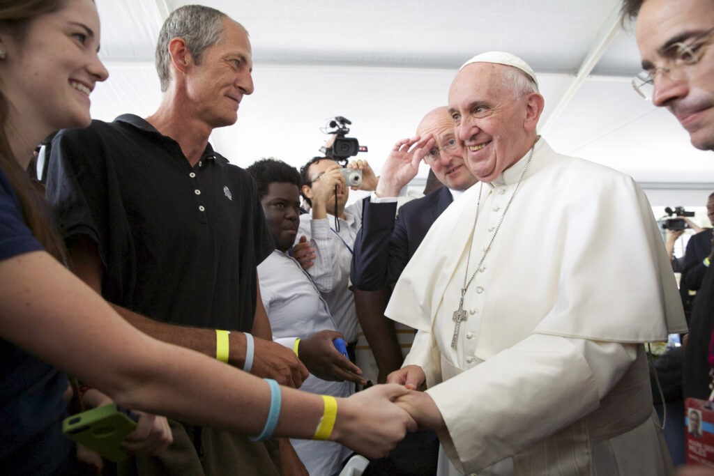 Pope Francis greets workers and clients at St. Maria's Meals Program of Catholic Charities in Washington Sept. 24. Pictured from left are Katie B. English, a volunteer from Rockville, Md., and client Frank Crosier. (CNS photo/Jaclyn Lippelmann, Catholic Standard)
