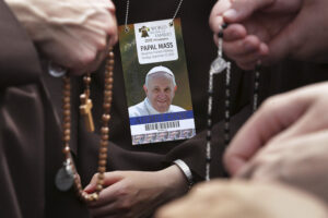 Members of the Sisters of St. Francis of Perpetual Adoration from Mishawaka, Ind., pray the rosary as they wait for the beginning of the final Mass of the World Meeting of Families in Philadelphia Sept. 27. Pope Francis was concluding his six-day visit to the United States by celebrating Mass before an estimated crowd of more than 1 million people. (CNS photo/Alex Wong, pool)