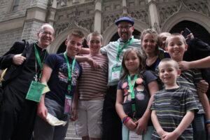 Bishop Olmsted stops for a picture with diocesan Marriage and Respect Life Director Mike Phelan, his wife Sharon, and their children, outside St. John's Parish Sept. 25. (Justin Bell/CATHOLIC SUN)