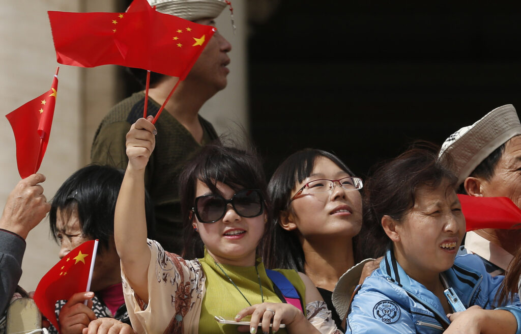 Pilgrims wave China's flag as Pope Francis leads his general audience in St. Peter's Square at the Vatican Sept. 16. (CNS photo/Paul Haring)