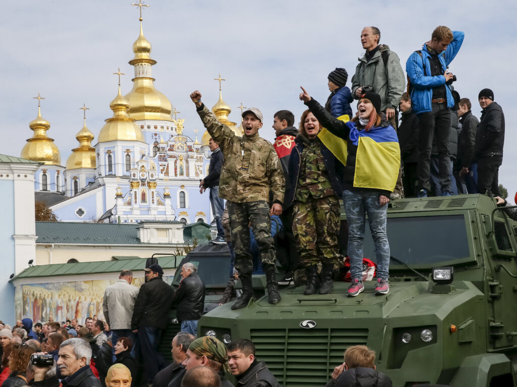 People take part in a rally near a church in Kiev, Ukraine, to mark Defenders Day Oct. 14. (CNS photo/Gleb Garanich, Reuters) 
